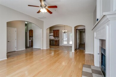 Unfurnished living room with light tile patterned flooring, ceiling fan with notable chandelier, and french doors