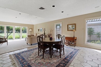 The open-concept dining and living area is bathed