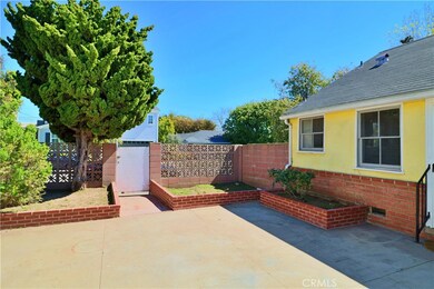 backyard patio area looking towards gate in block wall