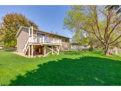 Chain link fenced in back yard with plush lawn.  L