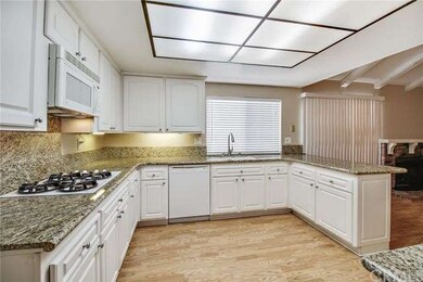 Kitchen with granite counter top, laminated wood f