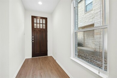 Entryway featuring wood finished floors and baseb