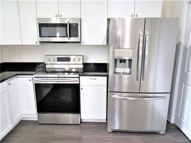 Kitchen features Brand New Stainless Steel Appliances including: Whirlpool Dishwasher, Samsung Smooth-Surface 5-Burner Stove, Samsung Built-in Microwave, and a 3-Door Frigidaire Refrigerator!