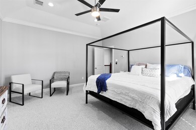 Your spacious primary suite offers a peaceful escape at the end of the day — soft carpet underfoot, modern lighting above, and room for a full sitting area make it the perfect place to recharge.