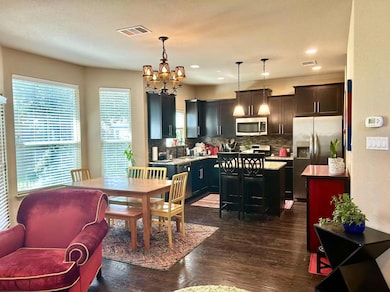 Dining area featuring a chandelier, dark wood-sty