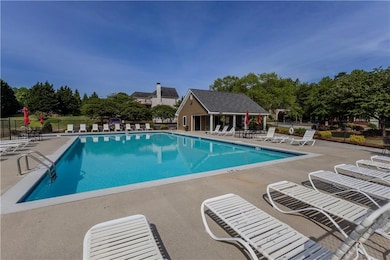 Community pool featuring a patio and fence