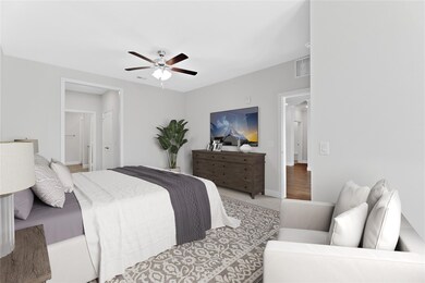 The bedroom has plenty of space for a sitting area