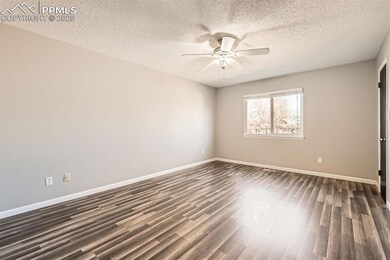 Unfurnished bedroom featuring baseboards, a textur