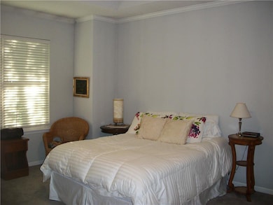 Master bedroom with walk-in closet and ceiling fan
