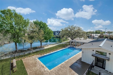 View of pool featuring a water view and a patio area