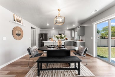 Dining room featuring light wood-type flooring, recessed lighting, and a chandelier