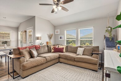 This living room is light and bright. Check out all of the natural light from the large windows on the back of the home.