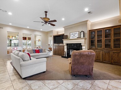 Large living room with built ins and a wood burnin