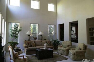 Formal living room has high ceilings with oversize