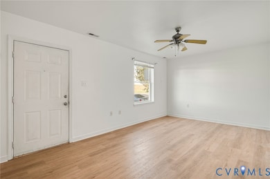 Entrance foyer with light wood-style floors and ceiling fan
