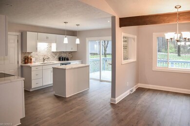 Open kitchen and dining room with a serving window