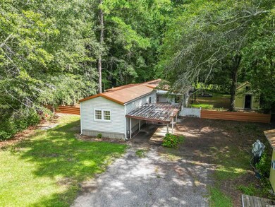 View of property exterior featuring a deck and a l