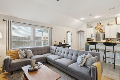 Living room featuring lofted ceiling, arched walkways, and recessed lighting