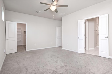 Unfurnished bedroom with carpet floors, a walk in
