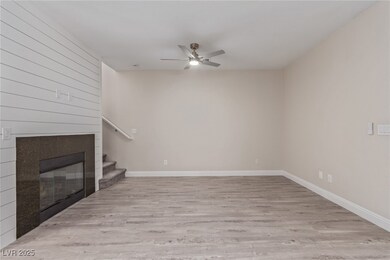 Unfurnished living room with a glass covered firep