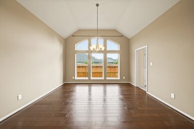 formal dining room and flex room with wood floors.