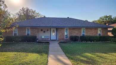 Ranch-style home with a front lawn