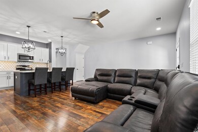 Living room featuring sink, ceiling fan with notab