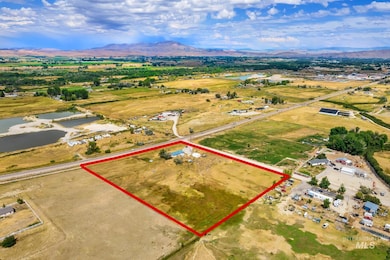 Aerial view of property and surrounding area featuring a water and mountain view and property boundaries highlighted