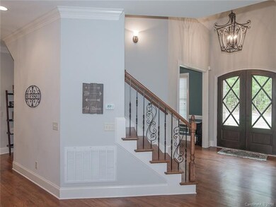 Custom wood doors and welcoming foyer with custom 