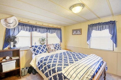 Carpeted bedroom featuring a textured ceiling and 