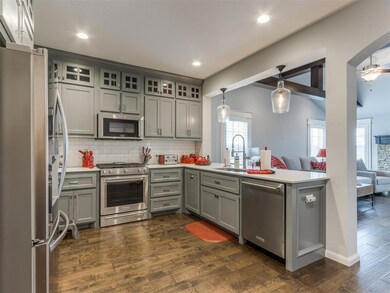 Kitchen with decorative light fixtures, tasteful b