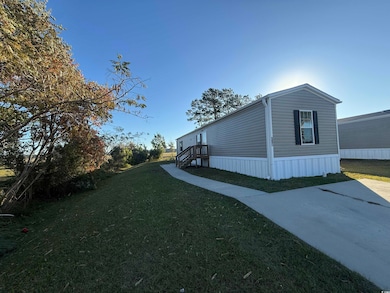 View of property exterior featuring a lawn