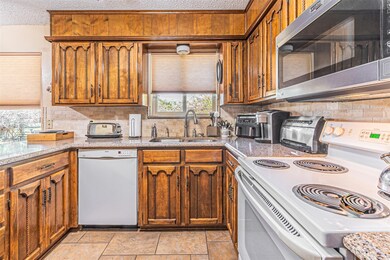 Kitchen featuring decorative backsplash, a texture