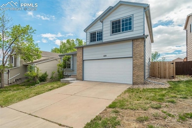 View of front of house featuring brick siding, a garage, and concrete driveway