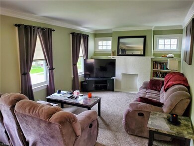 Spacious living room with ample natural lighting and brand new carpet.