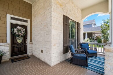 Inviting front porch is the perfect spot for year-round shade and meeting all of your fabulous neighbors.