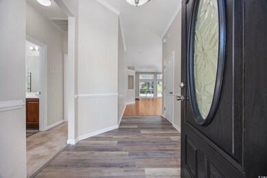 Entrance foyer with crown molding and light hardwo