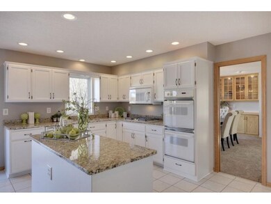Beautiful bright kitchen features granite tops, ce