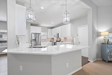 Quartz countertops.  Under cabinet lighting.  This kitchen is modern and clean.