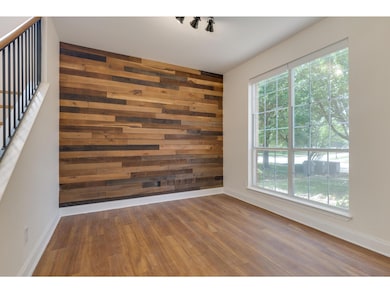 Spare room featuring wood walls, wood finished fl