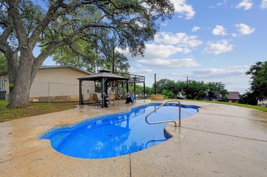 Swimming pool with a gazebo, a patio area, and a 