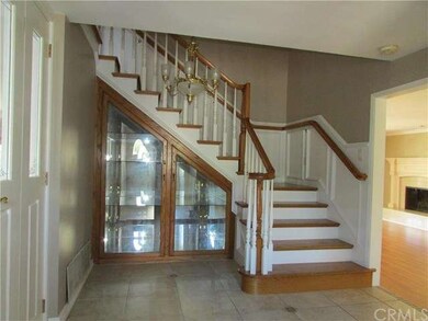 Entry and custom staircase with wainscoting