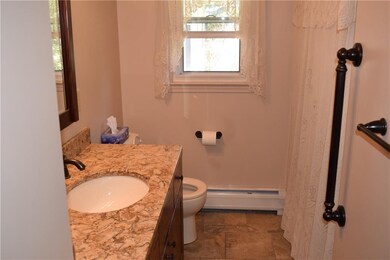 Updated bath with ceramic tiling and linen closet