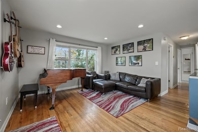 Living room featuring light wood-style flooring and recessed lighting