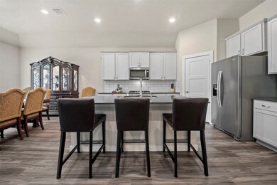 Large island with sink and 3 counter-height chairs