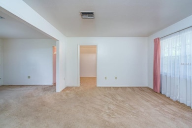 Formal living room leads into dining room. Family 
