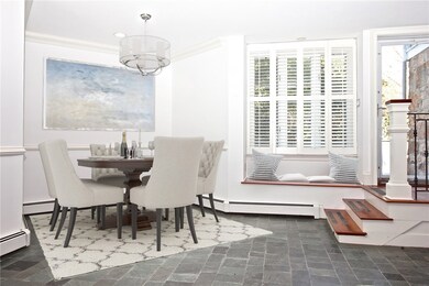 Virtually staged dining room / entry.