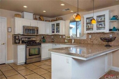 Kitchen offers stainless steel range and refrigera