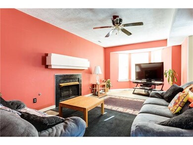 Family room has lovely bay window to catch the sun