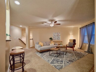 Spacious living room greets you at the top of the